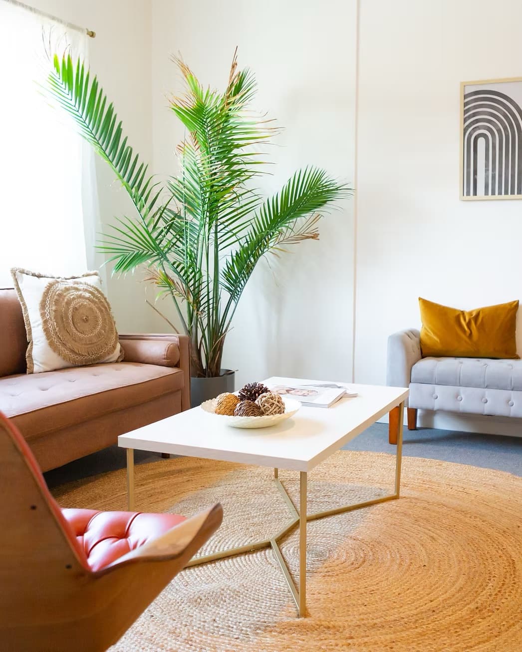 The warm, calming in-person therapy office in Bloomfield, NJ, soft couches, a tall palm, and natural light